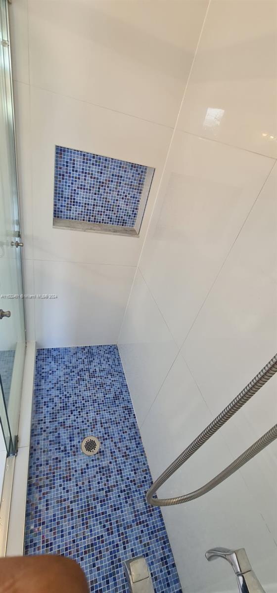 interior space featuring a tile shower