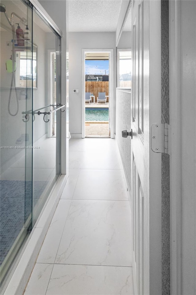 interior space with tile patterned floors and a textured ceiling