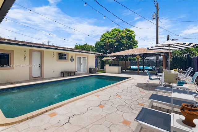 view of swimming pool featuring a gazebo and a patio area