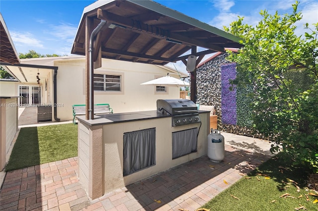 view of patio / terrace with an outdoor kitchen and a grill