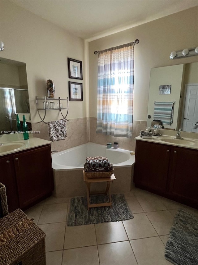 bathroom with vanity, tile patterned floors, and a bathing tub