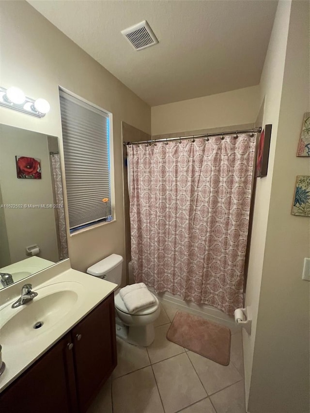 bathroom featuring tile patterned floors, toilet, and vanity