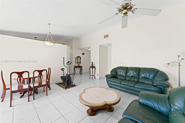 tiled living room with a textured ceiling and ceiling fan