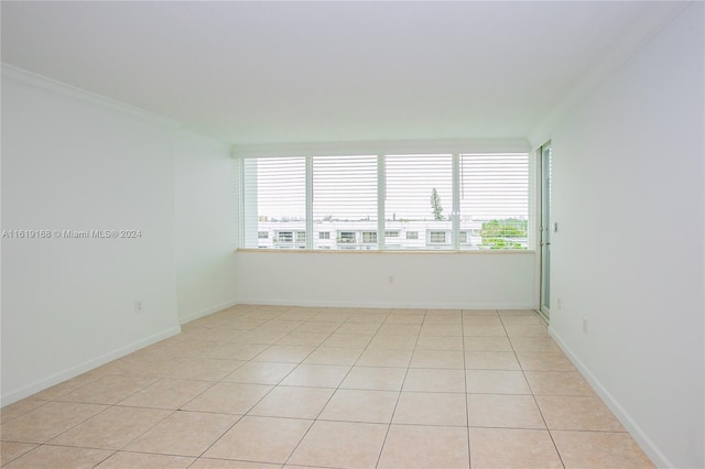 tiled empty room with crown molding