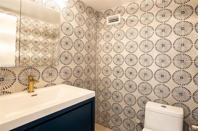 bathroom with toilet and vanity