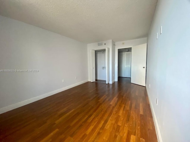 interior space featuring dark hardwood / wood-style floors and a textured ceiling