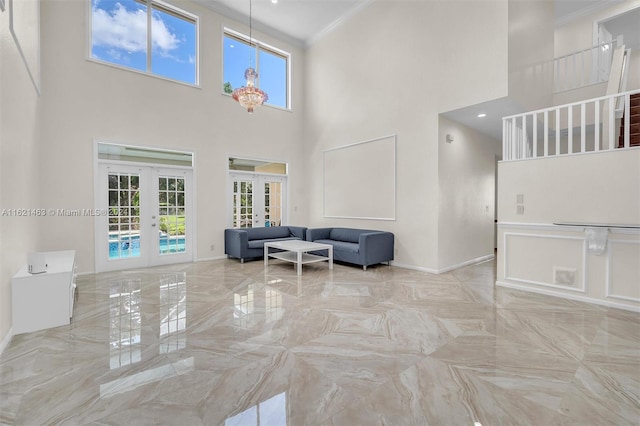 interior space featuring a high ceiling, french doors, and ornamental molding