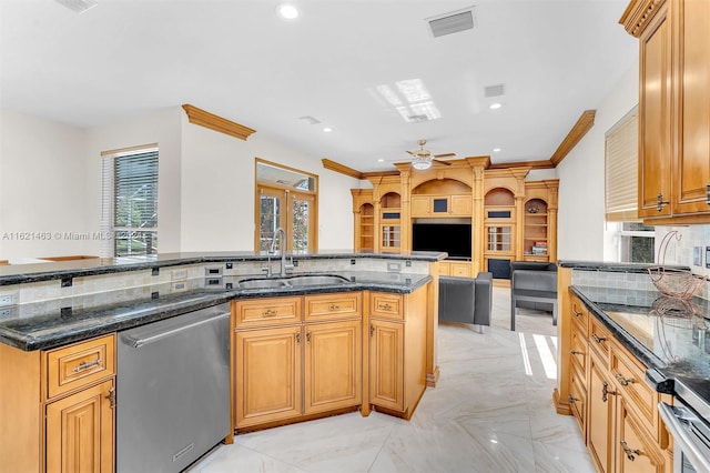 kitchen featuring dark stone counters, light tile patterned floors, sink, and stainless steel dishwasher