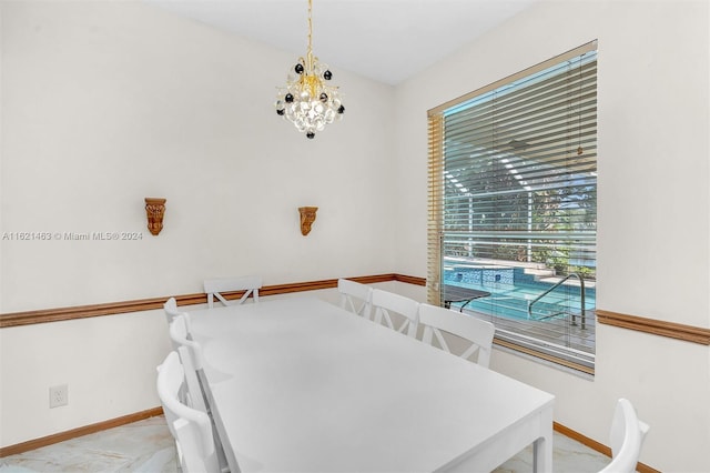 tiled dining space featuring a chandelier