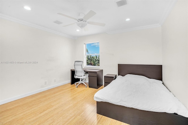 bedroom with crown molding, ceiling fan, and light hardwood / wood-style floors