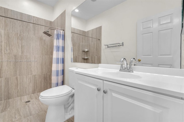 bathroom with vanity, a shower with shower curtain, and toilet