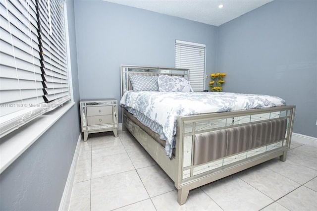 bedroom with light tile patterned floors