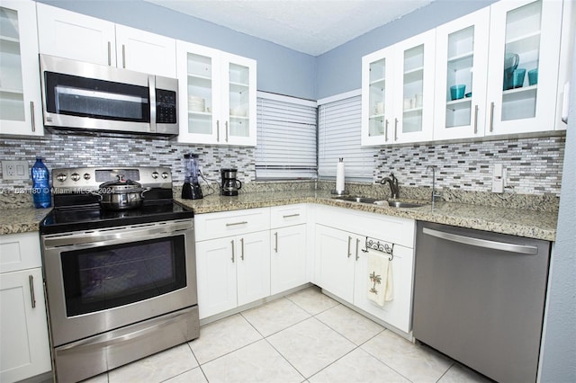 kitchen featuring sink, appliances with stainless steel finishes, and tasteful backsplash