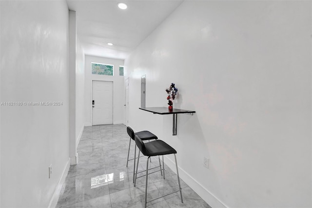 hall with light tile patterned flooring