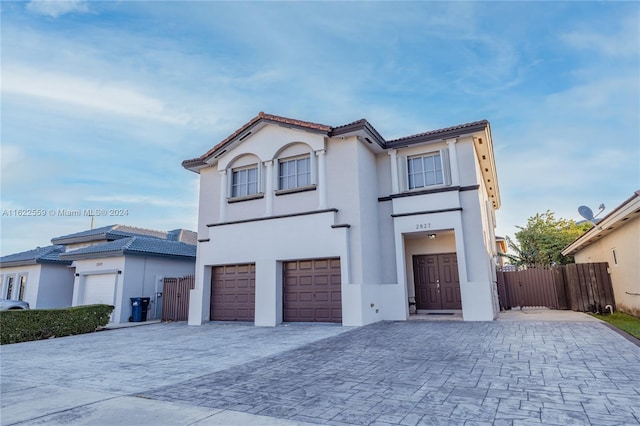 mediterranean / spanish house with a garage