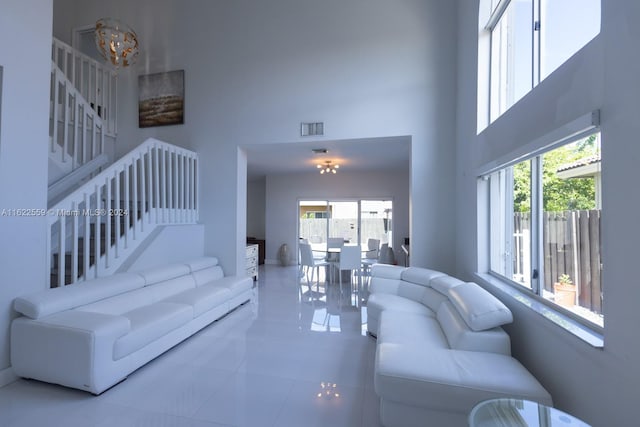 tiled living room featuring a high ceiling