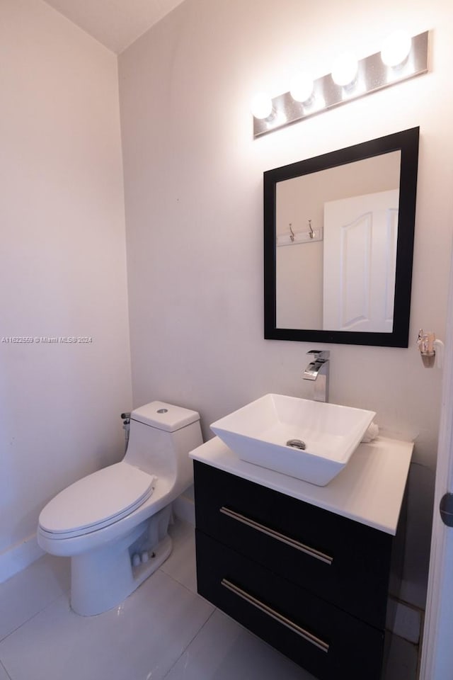 bathroom featuring tile patterned floors, vanity, and toilet