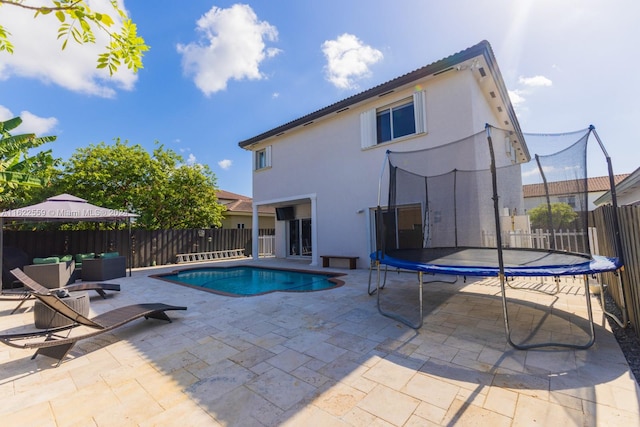 view of pool featuring a patio and a trampoline