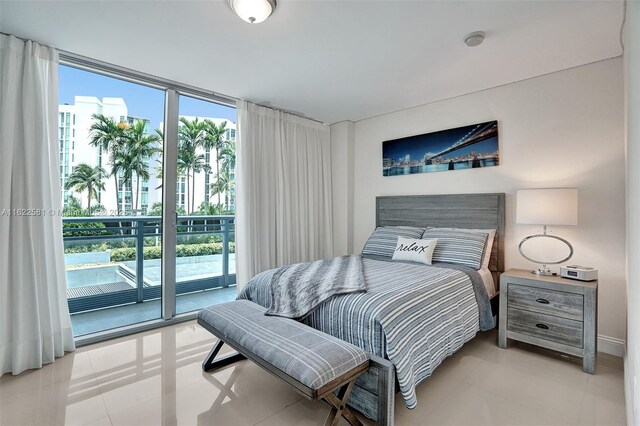 tiled bedroom featuring access to exterior and a wall of windows