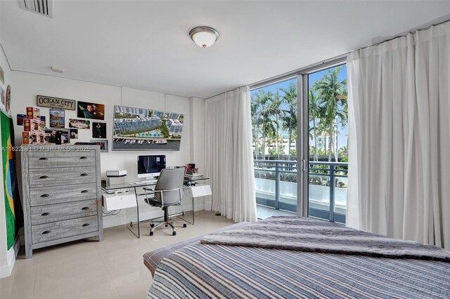 tiled bedroom featuring access to outside and a wall of windows