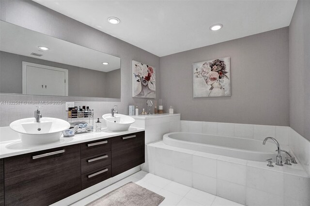 bathroom with decorative backsplash, vanity, tile patterned floors, and an enclosed shower