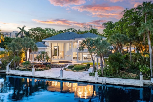 back house at dusk with a patio