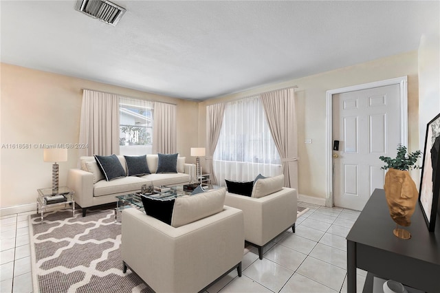 living room featuring a textured ceiling and light tile patterned flooring