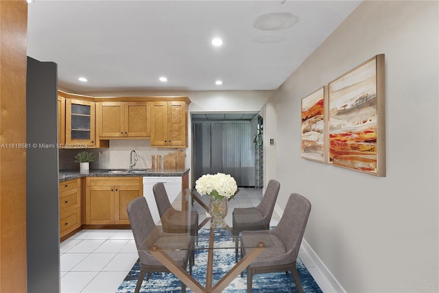 dining area featuring light tile patterned flooring and sink