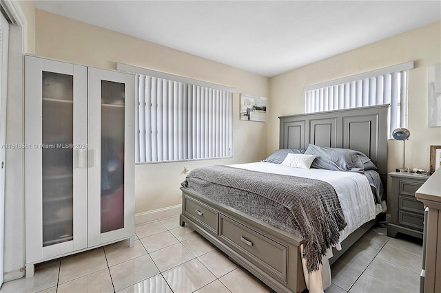 bedroom featuring light tile patterned floors