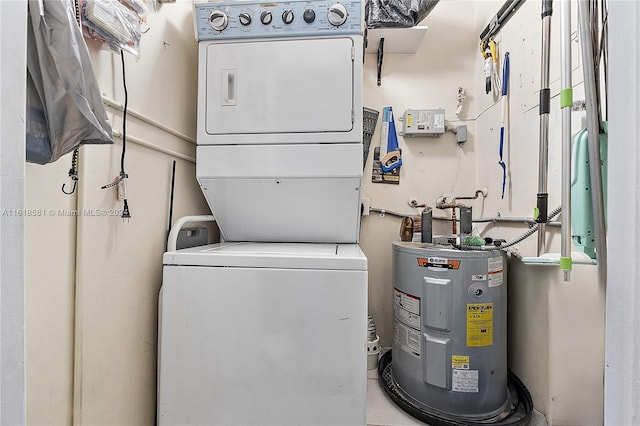 washroom featuring electric water heater and stacked washer / drying machine