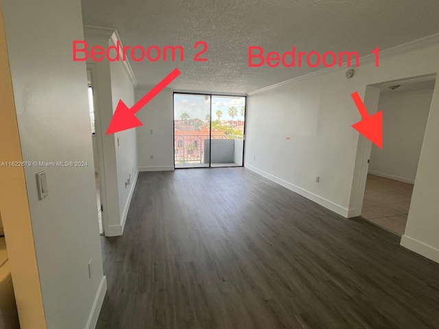 unfurnished living room featuring crown molding, dark wood-type flooring, and a textured ceiling