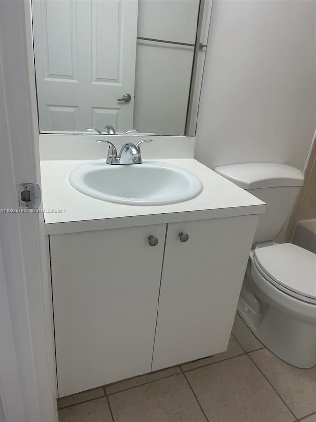 bathroom featuring toilet, vanity, and tile patterned floors