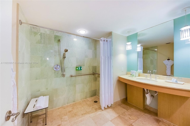 bathroom featuring sink, curtained shower, and tile patterned floors