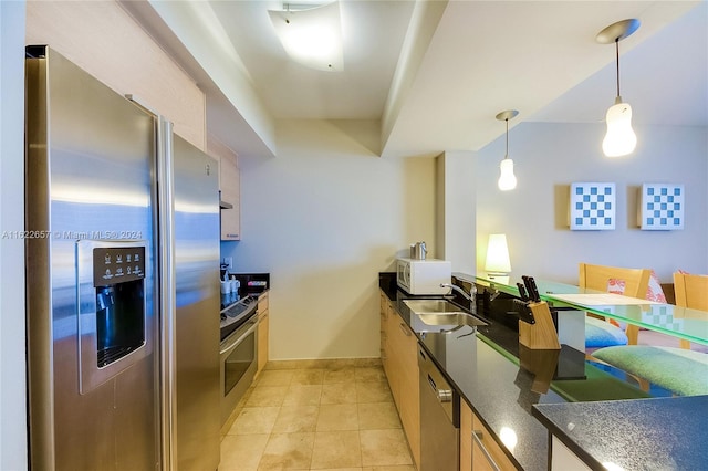 kitchen featuring sink, light tile patterned flooring, pendant lighting, and stainless steel appliances