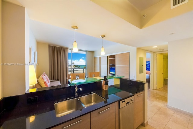 kitchen with sink, decorative light fixtures, light tile patterned floors, and white dishwasher