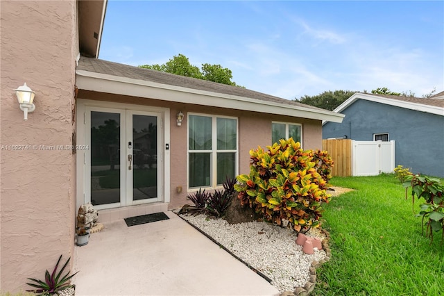 exterior space featuring french doors and a lawn