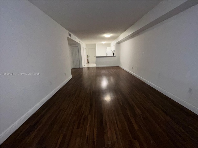 unfurnished room featuring dark wood-type flooring