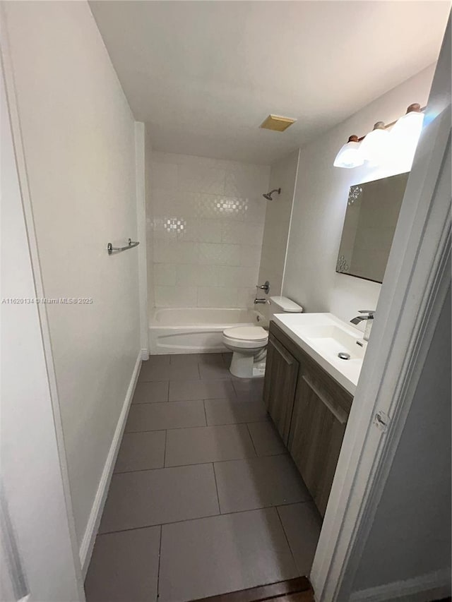 bathroom featuring tile patterned flooring, baseboards, toilet, shower / bathtub combination, and vanity