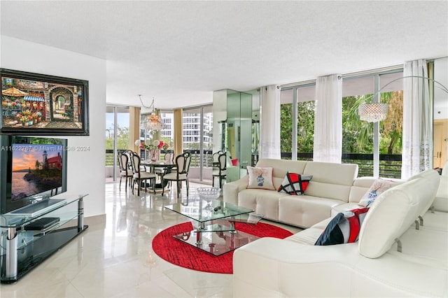 living room featuring a textured ceiling and a wall of windows