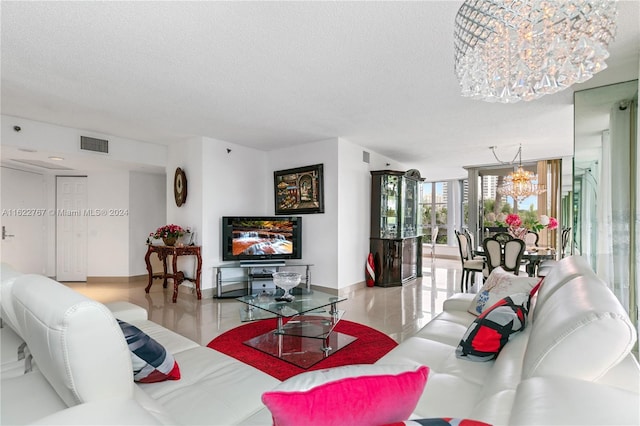 living room featuring expansive windows, a notable chandelier, and a textured ceiling