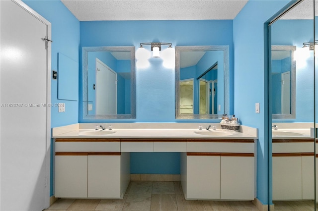 bathroom featuring vanity and a textured ceiling