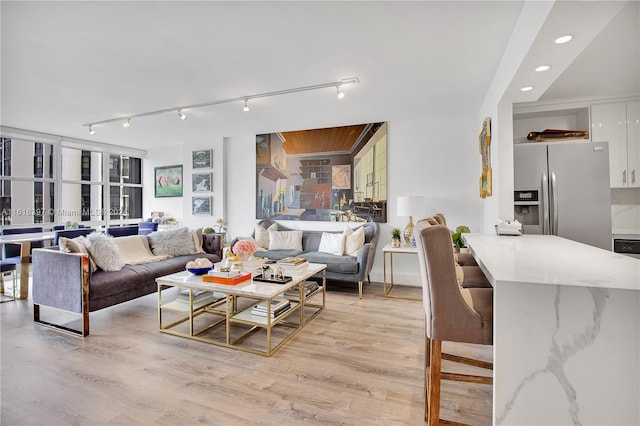 living room with track lighting and light wood-type flooring