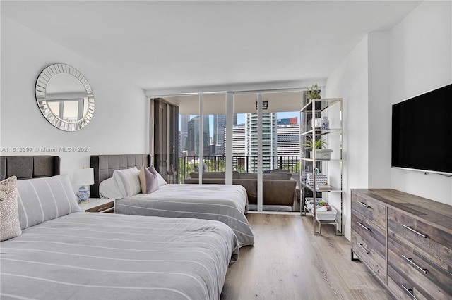 bedroom featuring access to outside and light wood-type flooring