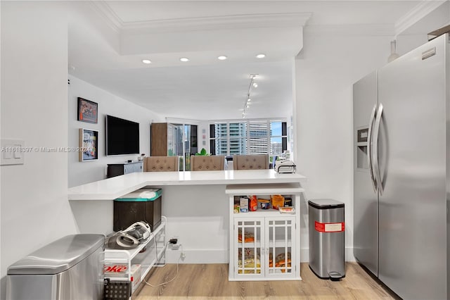 kitchen featuring stainless steel fridge with ice dispenser, light hardwood / wood-style floors, track lighting, and ornamental molding