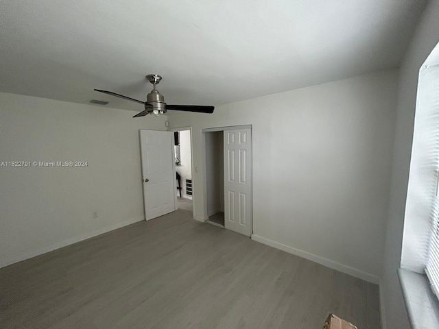 unfurnished room with hardwood / wood-style floors and ceiling fan