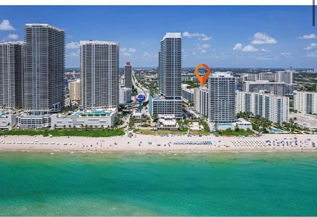 exterior space featuring a water view and a beach view