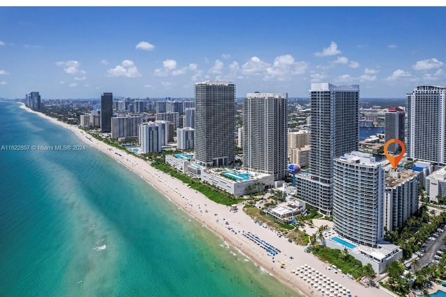 exterior space with a water view and a beach view