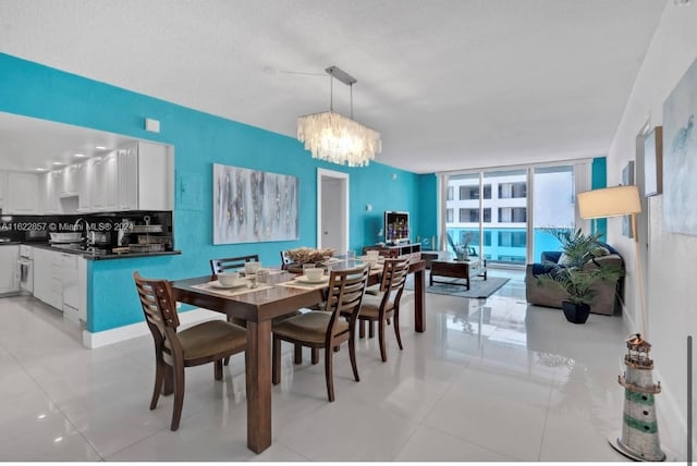 tiled dining space with a chandelier, a textured ceiling, and floor to ceiling windows