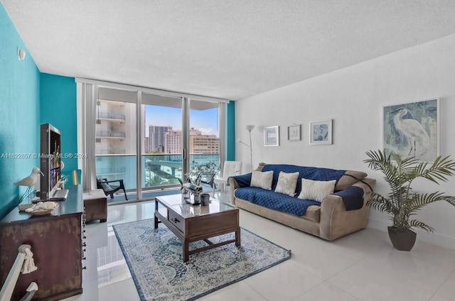 living room featuring tile patterned floors, a textured ceiling, and floor to ceiling windows