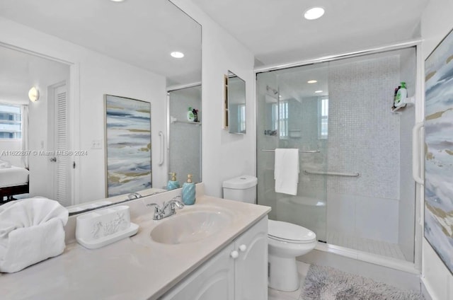 bathroom featuring vanity, toilet, an enclosed shower, and tile patterned flooring